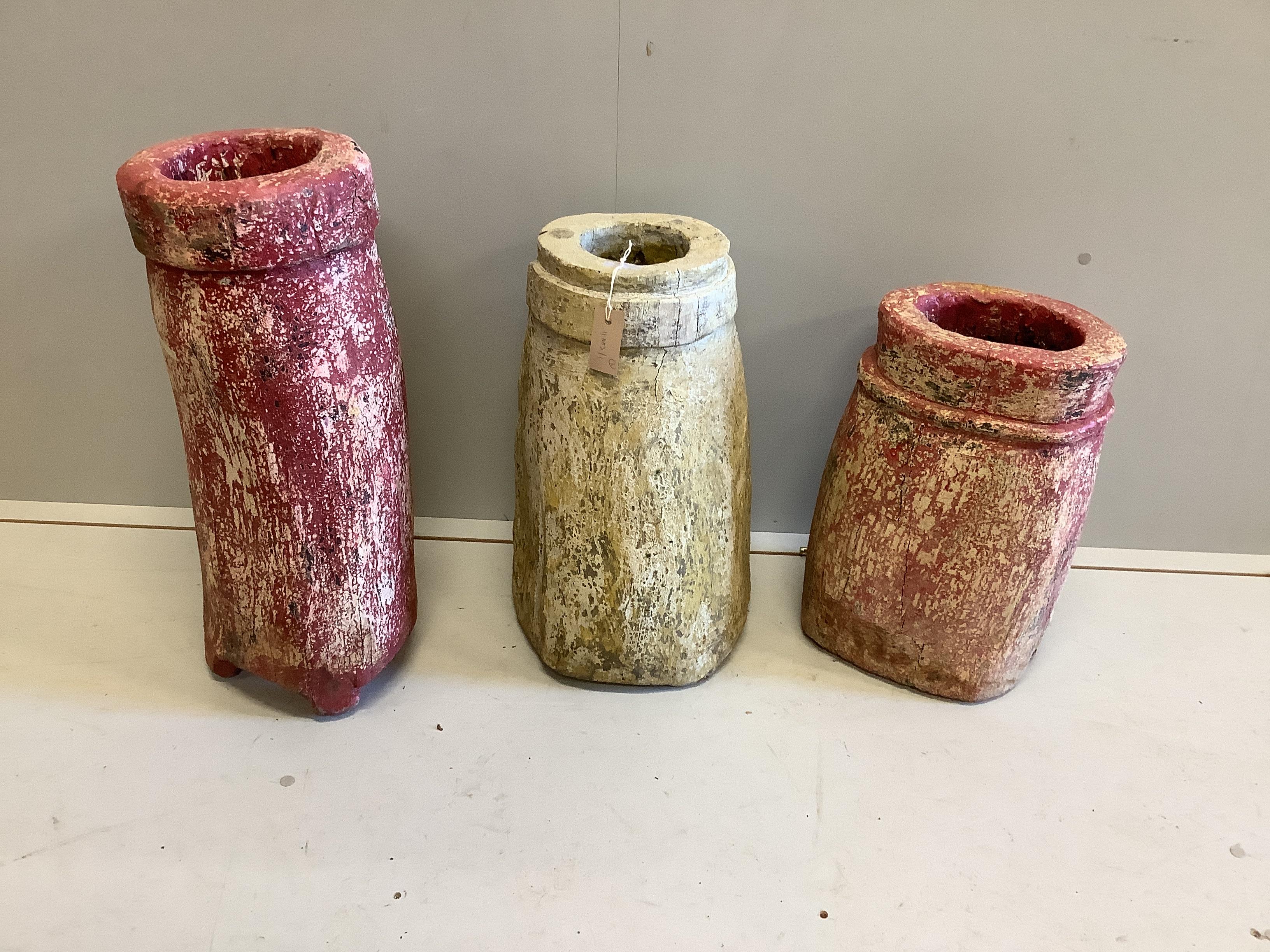 Three painted wood mortars, largest height 63cm